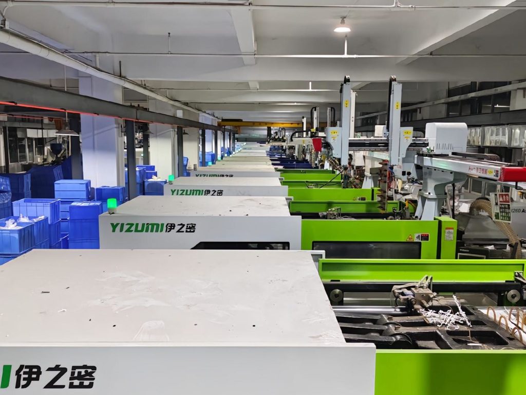 An injection molding machine producing plastic components in a manufacturing facility.