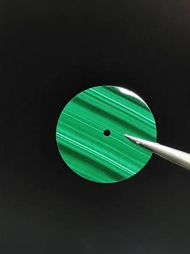Polished Malachite with vivid green concentric bands.