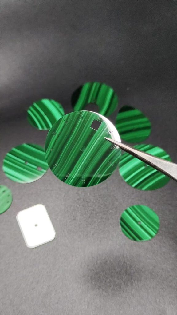 Polished Malachite with vivid green concentric bands.