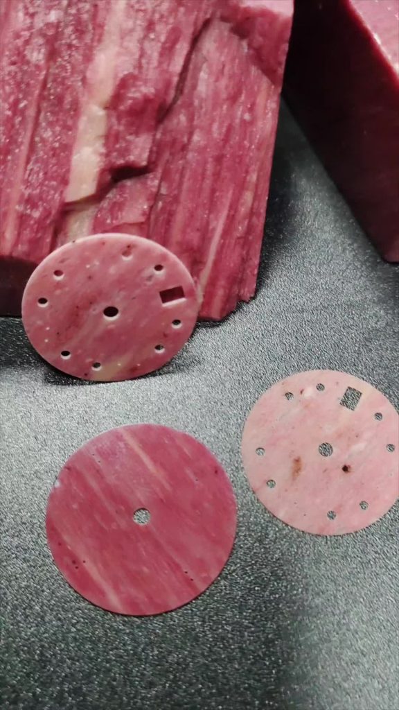 Rhodochrosite gemstone with soft pink and white banding.